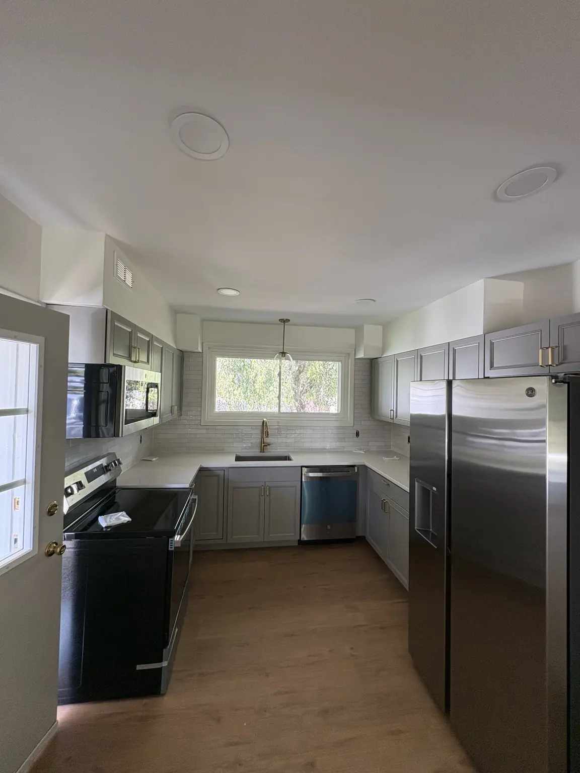 Completed Alabaster satin repaint in a bright kitchen with gray cabinetry