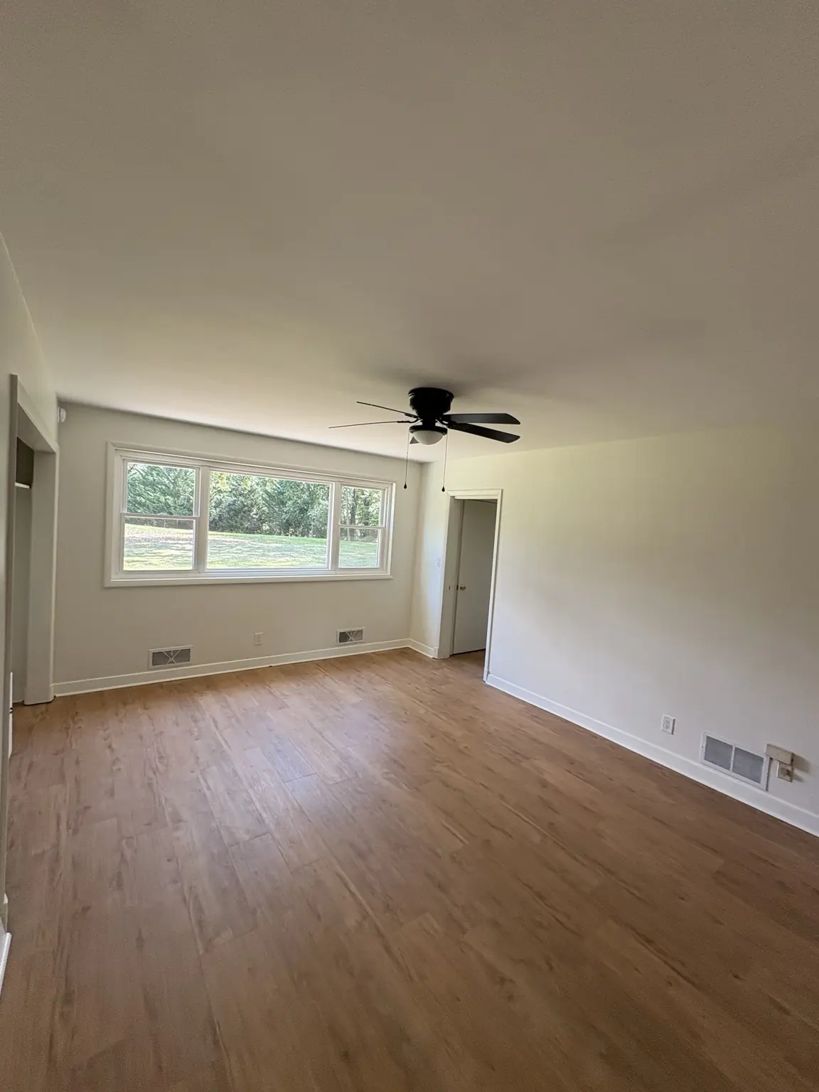 Finished living room with an even Alabaster satin repaint and crisp white trim