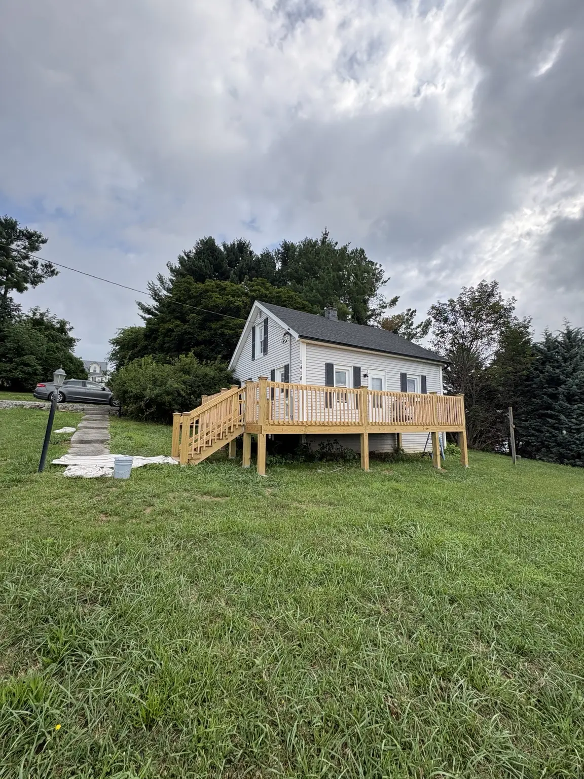 Wide view of the unstained natural wood deck before finishing