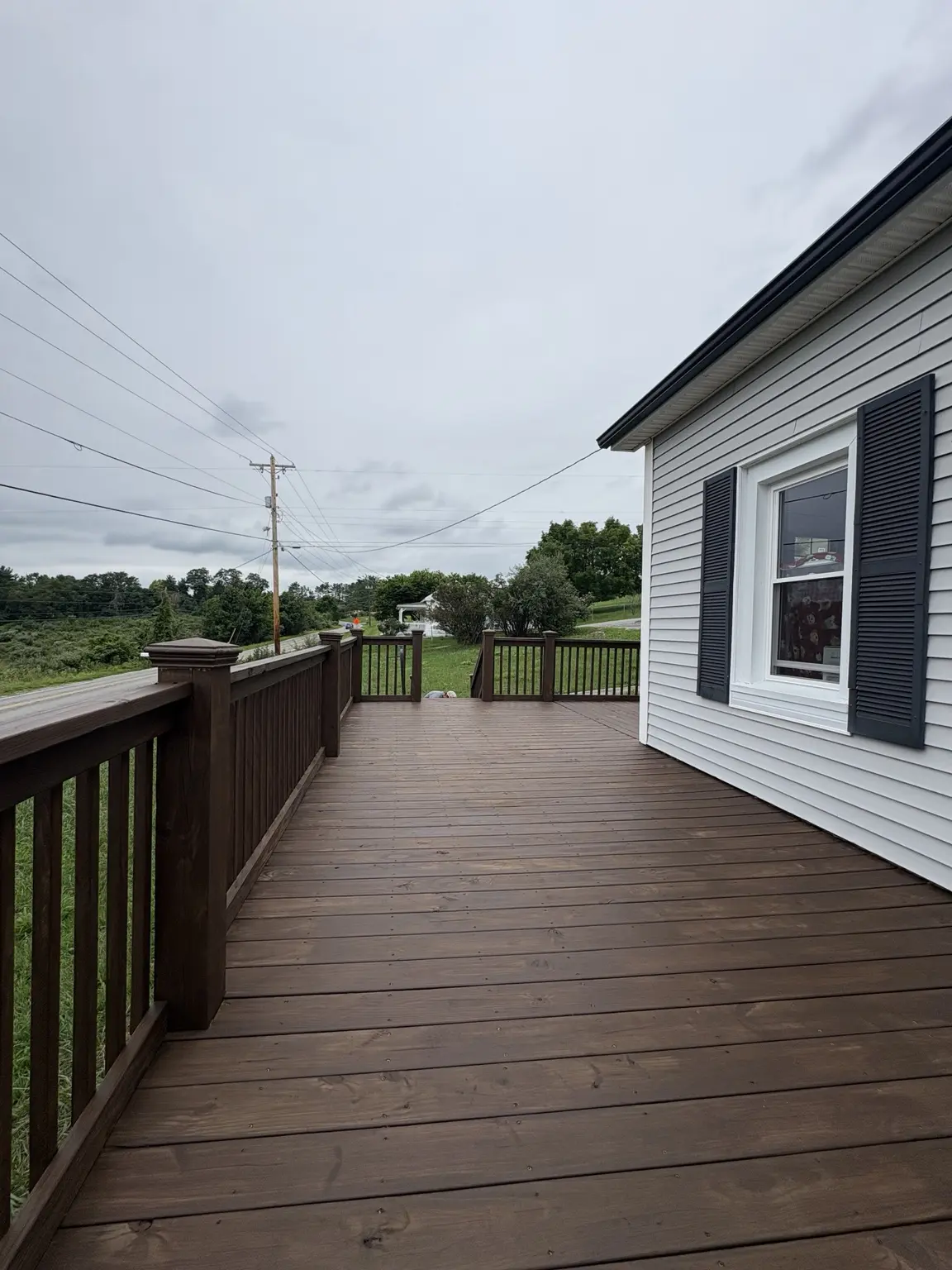 Finished deck boards and railings with an even semi-transparent brown stain